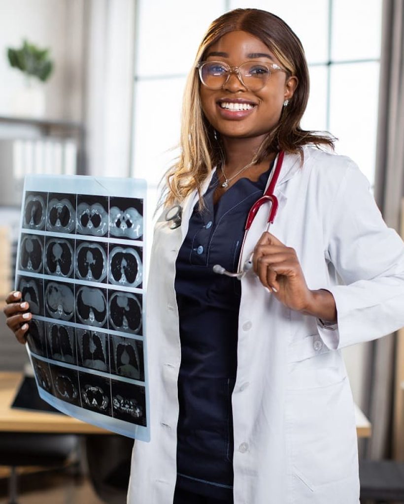 african-woman-gp-doctor-posing-to-camera-in-her-m-2023-11-27-05-01-23-utc