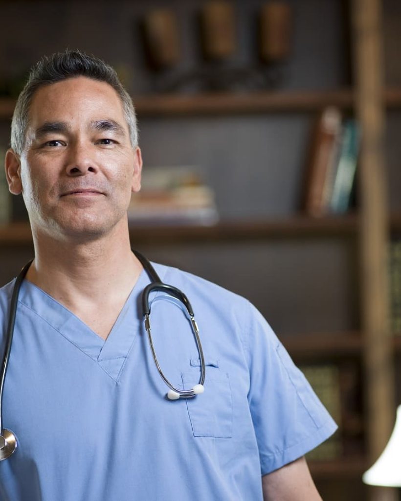 portrait-of-smiling-mature-doctor-in-office-2024-06-05-15-11-06-utc